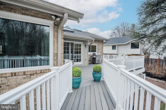 wooden deck with a grill