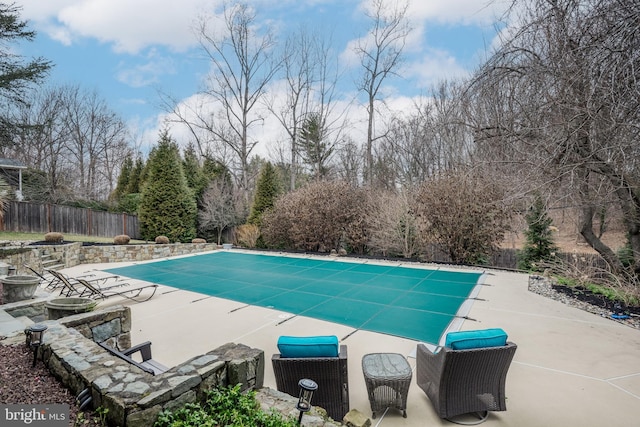 view of pool featuring a fenced in pool, fence, and a patio area