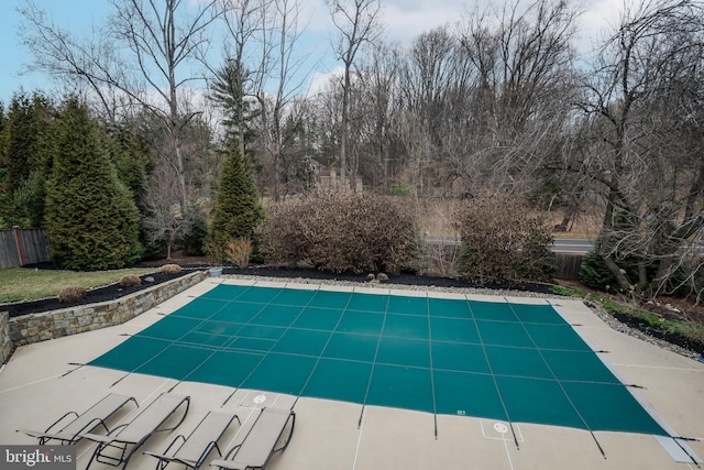 view of swimming pool with fence