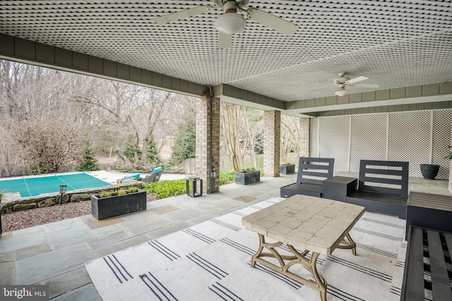 view of patio / terrace with a covered pool and a ceiling fan