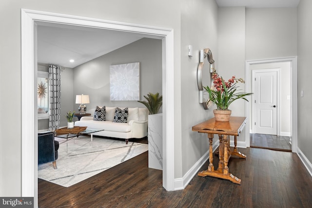 hallway featuring recessed lighting, baseboards, and wood-type flooring