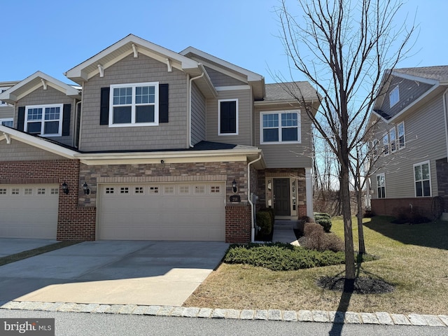 view of front of home featuring an attached garage, brick siding, stone siding, and driveway