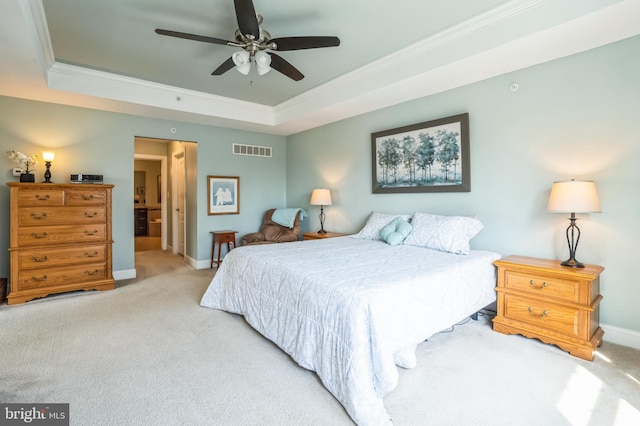 bedroom with baseboards, visible vents, ornamental molding, light carpet, and a raised ceiling