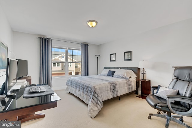 bedroom with baseboards and carpet