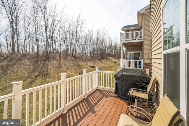 wooden terrace with a grill