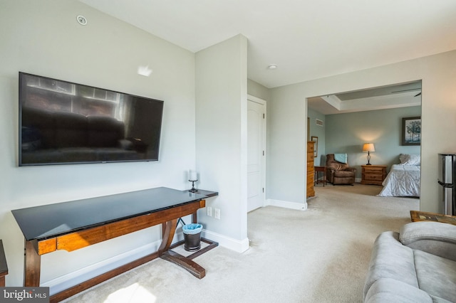 carpeted living room with baseboards