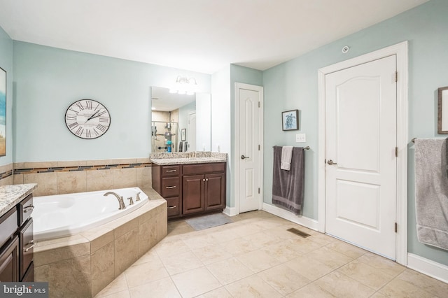 full bathroom with vanity, visible vents, tile patterned flooring, a shower stall, and a garden tub