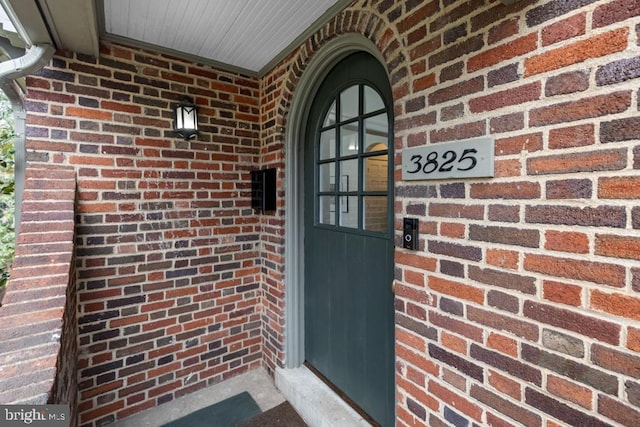 property entrance with brick siding