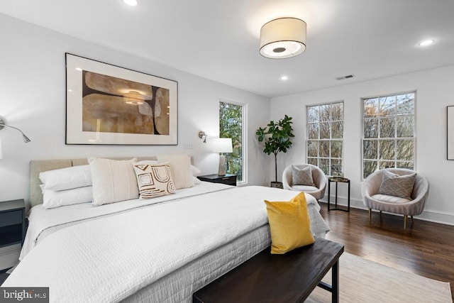 bedroom with recessed lighting, visible vents, baseboards, and wood finished floors