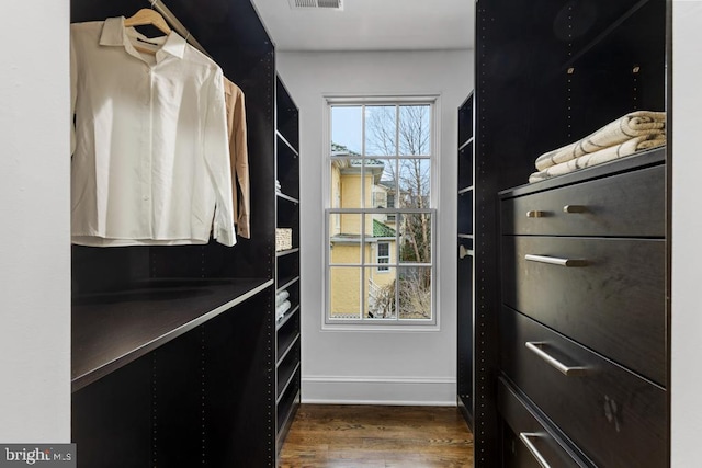 walk in closet with visible vents and dark wood-type flooring