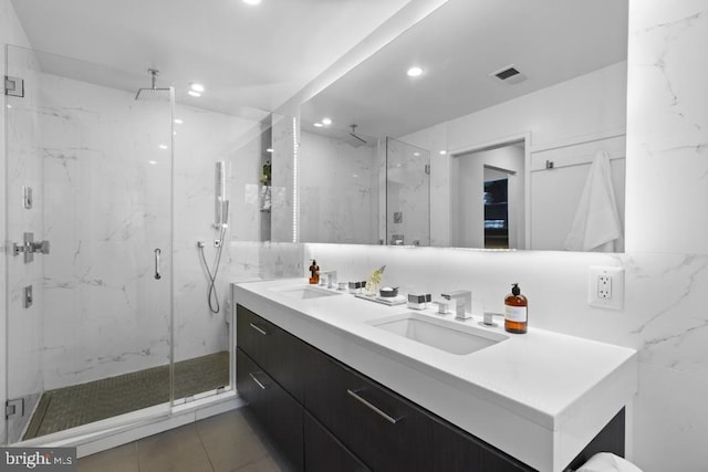 full bath with double vanity, recessed lighting, a marble finish shower, and a sink