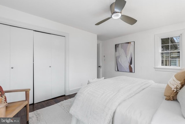 bedroom featuring a ceiling fan, wood finished floors, and a closet