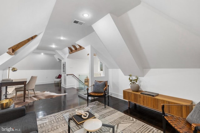 interior space featuring visible vents, baseboards, hardwood / wood-style floors, vaulted ceiling, and recessed lighting