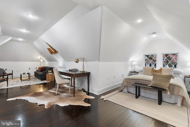 bedroom featuring visible vents, baseboards, vaulted ceiling, and hardwood / wood-style flooring