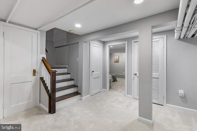 finished basement featuring stairway, recessed lighting, baseboards, and light carpet