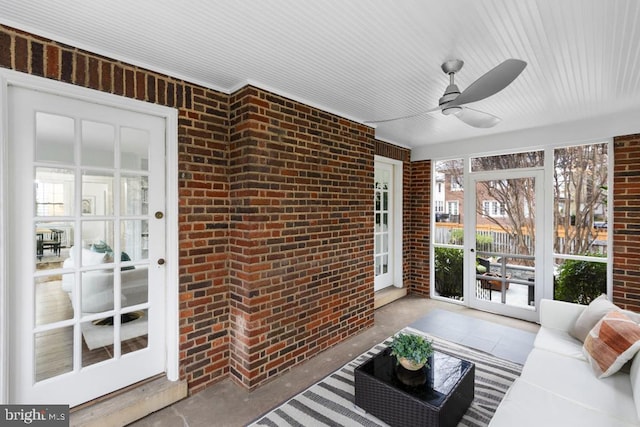 sunroom featuring a ceiling fan