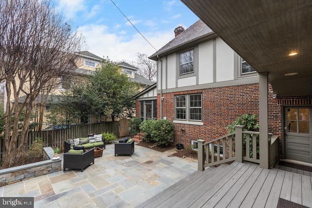 wooden deck featuring a patio area, fence, and an outdoor hangout area