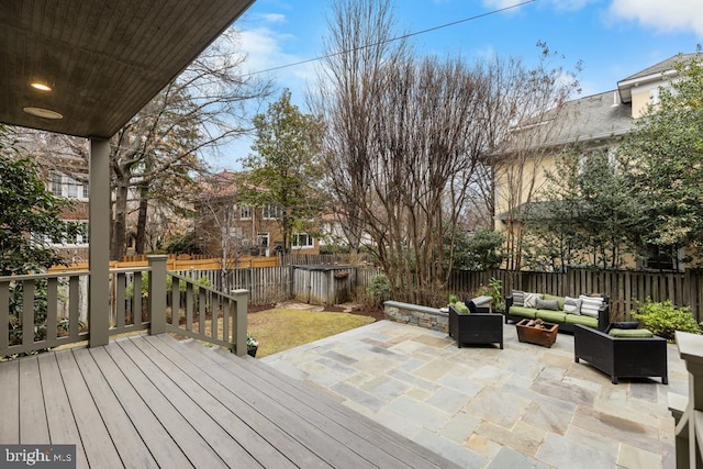 deck featuring an outdoor hangout area, a patio, and a fenced backyard