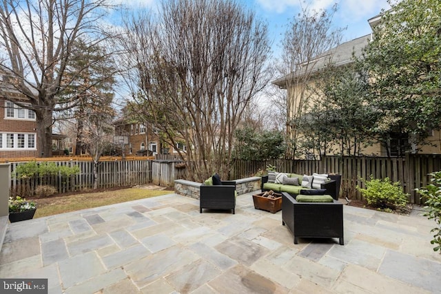 view of patio featuring an outdoor living space with a fire pit and a fenced backyard