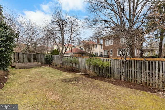 view of yard with a fenced backyard and a garden