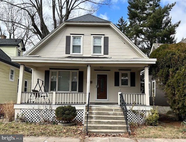 bungalow-style house with a gambrel roof and a porch