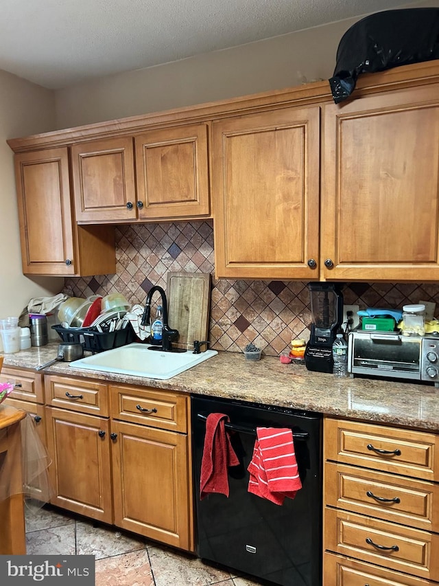 kitchen with a sink, backsplash, dishwasher, and light countertops