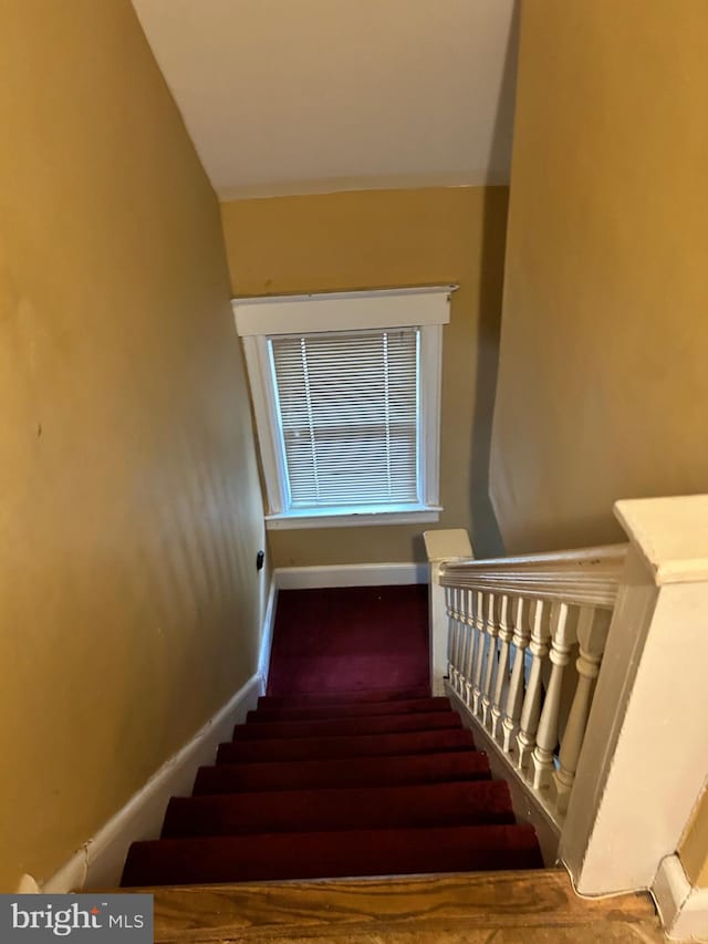 stairway featuring baseboards