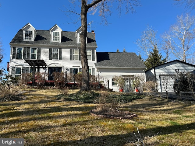 view of front facade with a chimney and a front lawn