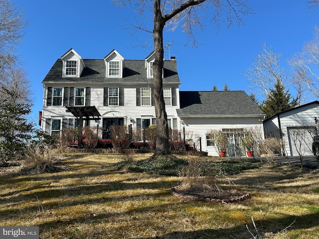 view of front of property with a front yard and a chimney