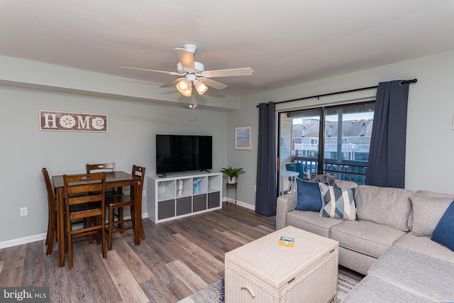 living room with baseboards, a ceiling fan, and wood finished floors