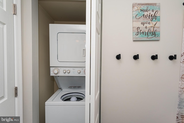 laundry area with stacked washer / drying machine