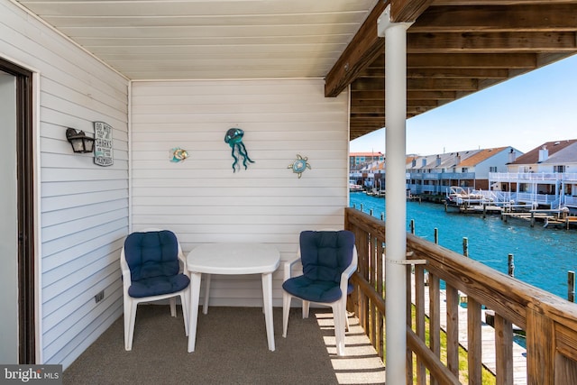 balcony with a residential view and a water view