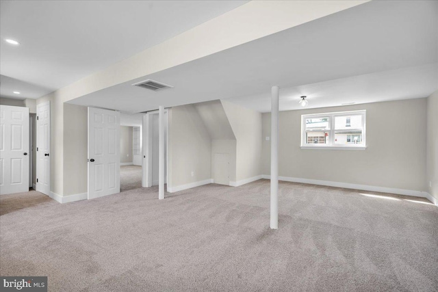 below grade area featuring recessed lighting, visible vents, carpet floors, and baseboards