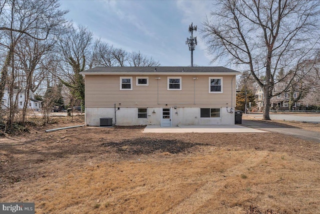 rear view of property featuring a patio area and central AC