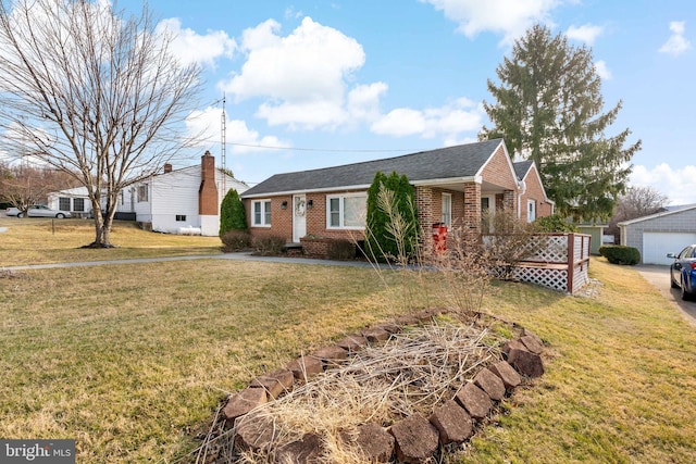 single story home featuring a front yard, an outbuilding, brick siding, and a shingled roof