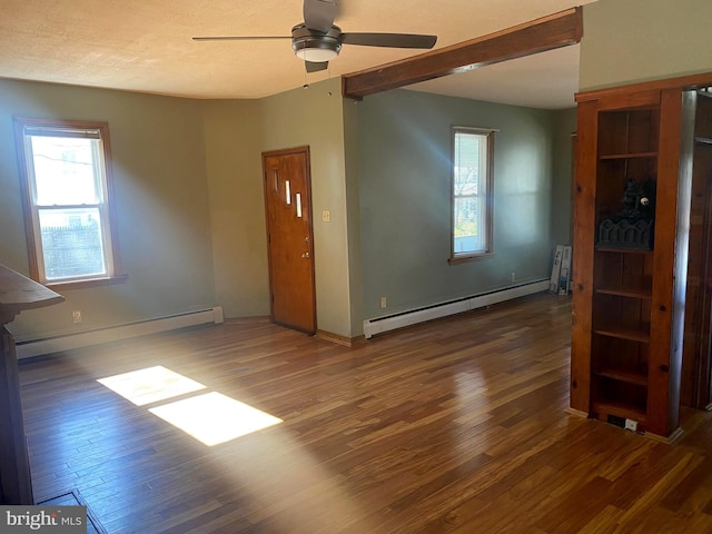 empty room with baseboards, a baseboard heating unit, a ceiling fan, and wood finished floors