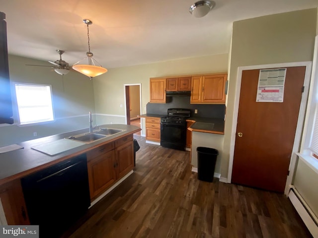 kitchen featuring black appliances, a sink, under cabinet range hood, dark wood-style floors, and baseboard heating