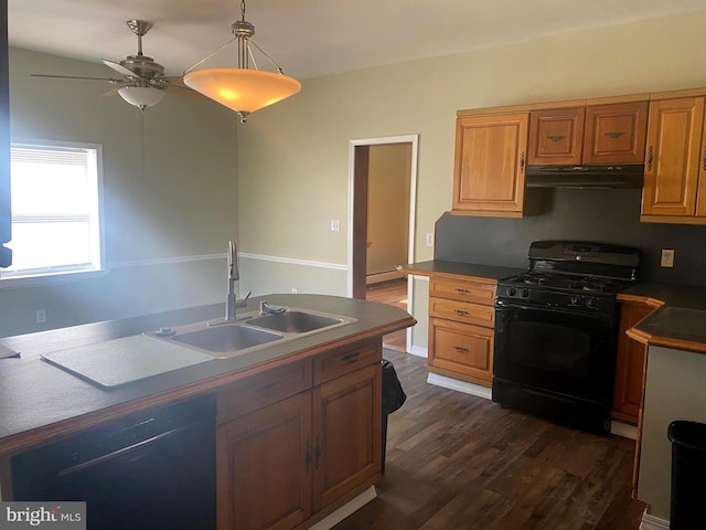 kitchen featuring dark wood-style floors, a sink, black appliances, under cabinet range hood, and a baseboard heating unit