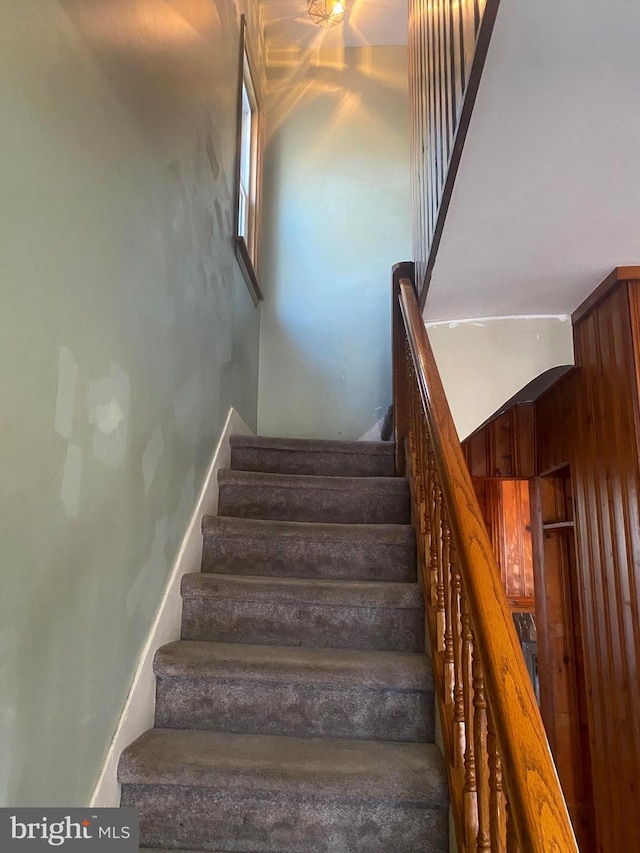 staircase featuring baseboards