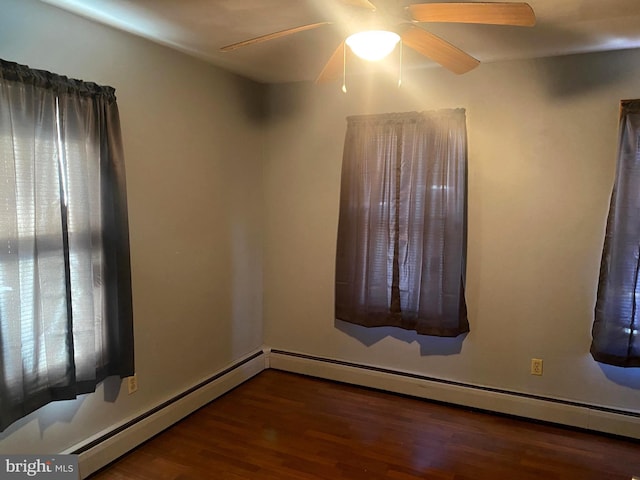 empty room with a ceiling fan and wood finished floors