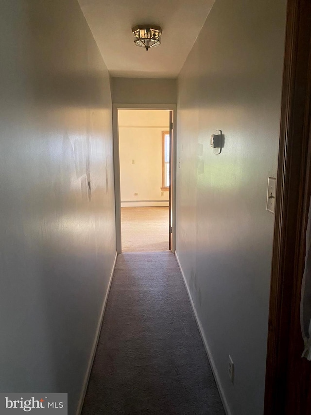 corridor featuring baseboards, carpet, and a baseboard radiator