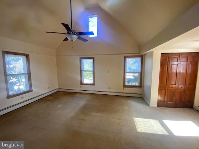 carpeted empty room with a baseboard heating unit, lofted ceiling, and a ceiling fan