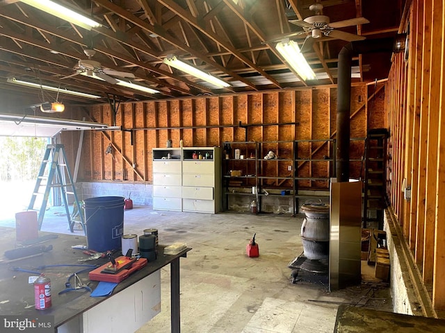 garage with ceiling fan and a garage door opener