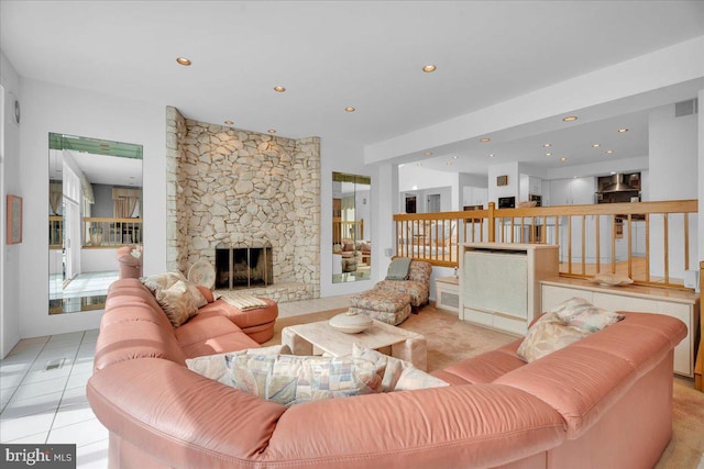 living room featuring light tile patterned floors, visible vents, recessed lighting, and a fireplace