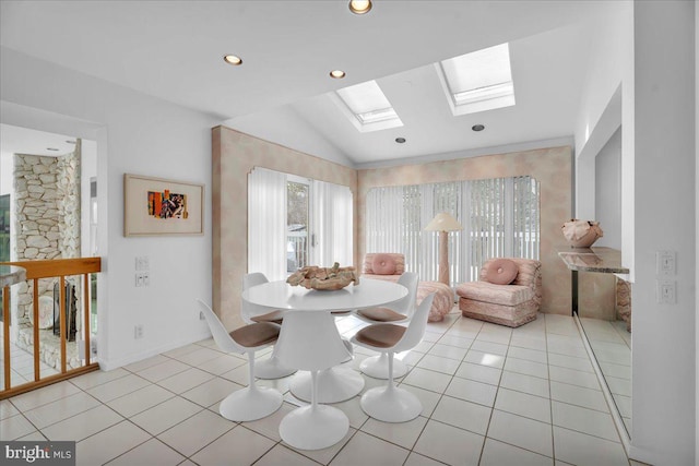 dining space with light tile patterned floors, plenty of natural light, recessed lighting, and lofted ceiling with skylight