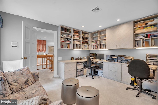 office space with light carpet, visible vents, recessed lighting, and built in study area