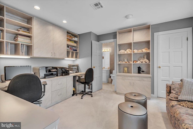 office area with light carpet, visible vents, recessed lighting, and built in desk