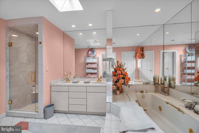 bathroom with vanity, a shower stall, a skylight, and a tub with jets