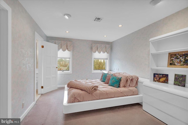 bedroom featuring wallpapered walls and visible vents