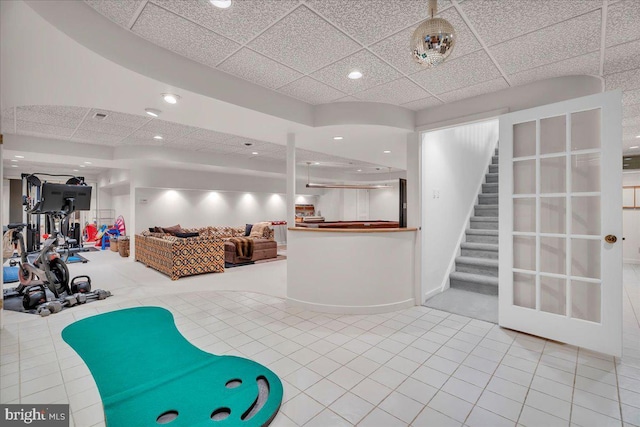 interior space featuring tile patterned floors, stairway, recessed lighting, and a drop ceiling